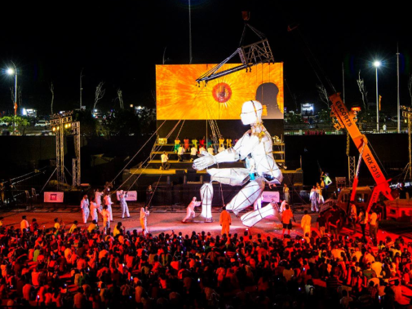Photograph of an outside performance with large puppet