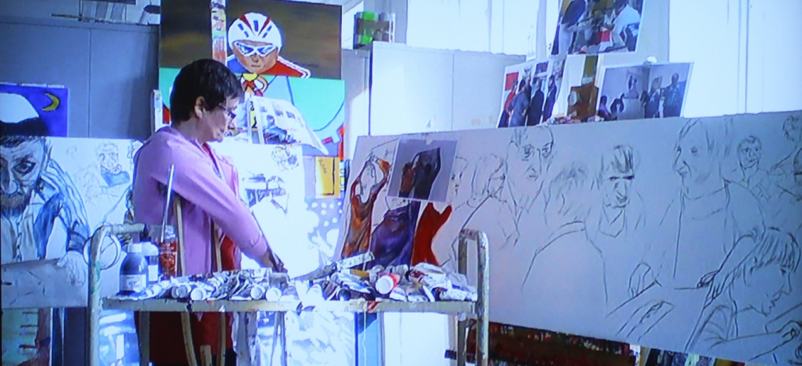 Woman with crutches working in a studio on a large panoramic painting