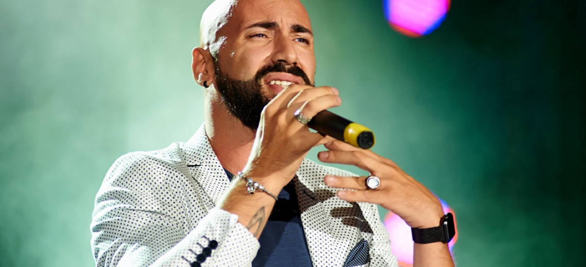 A man holding a microphone up to his face. 