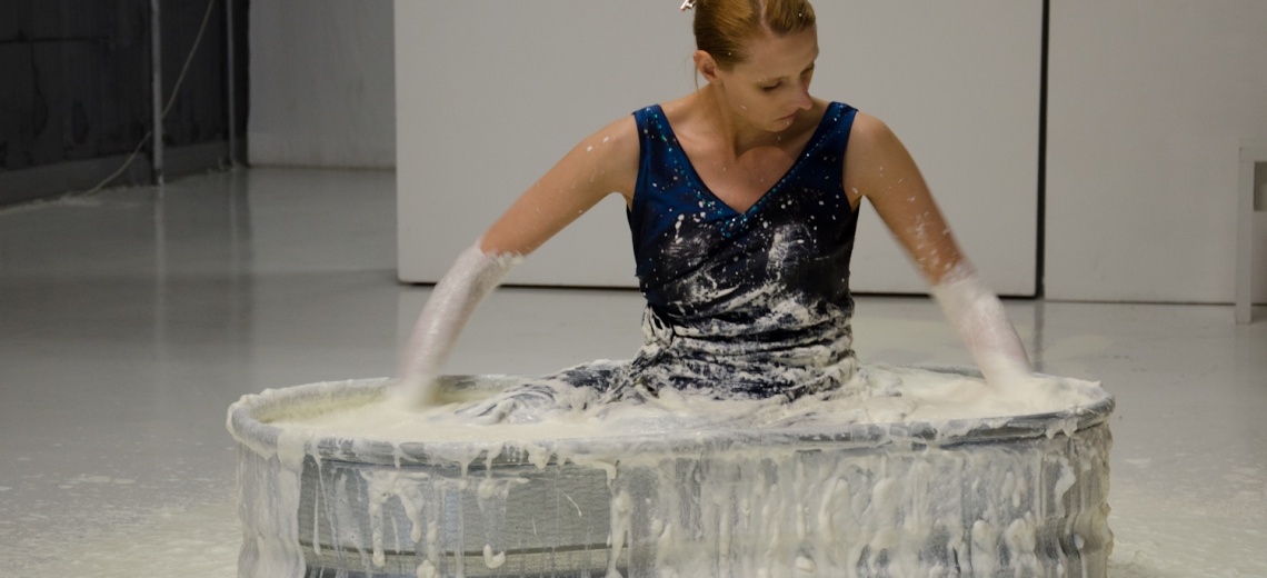 Woman in vat of white liquid