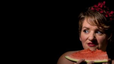 Woman eating a slice of watermelon