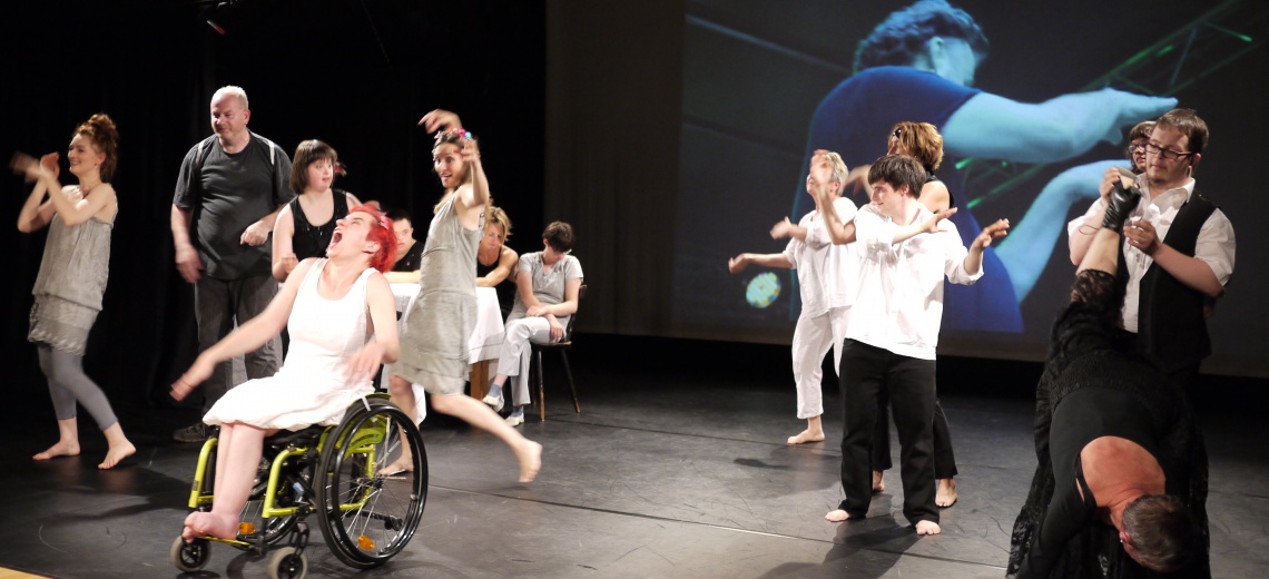 A large group of male and female performers on a stage 