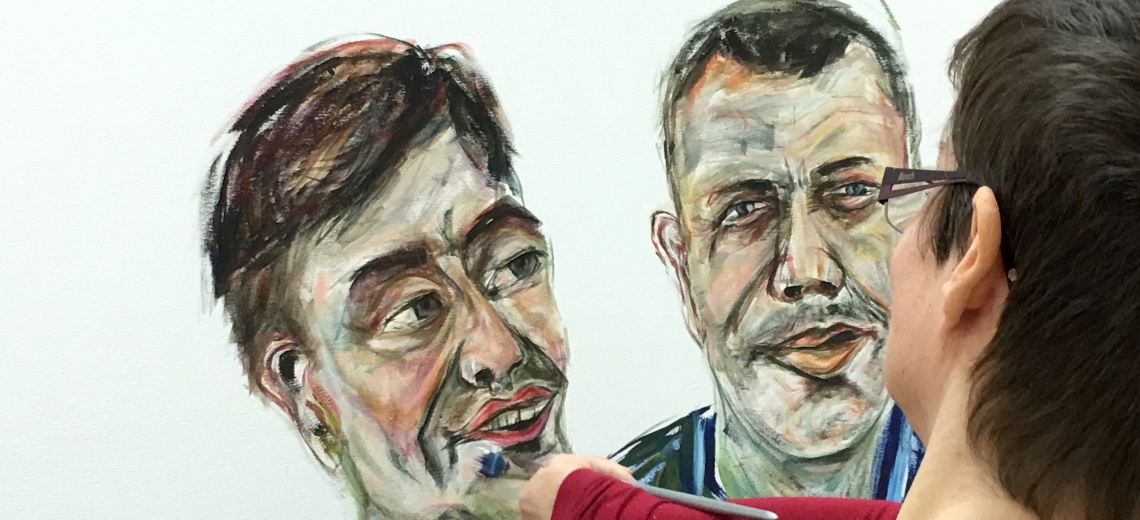 Woman painting oil portrait of a gay couple