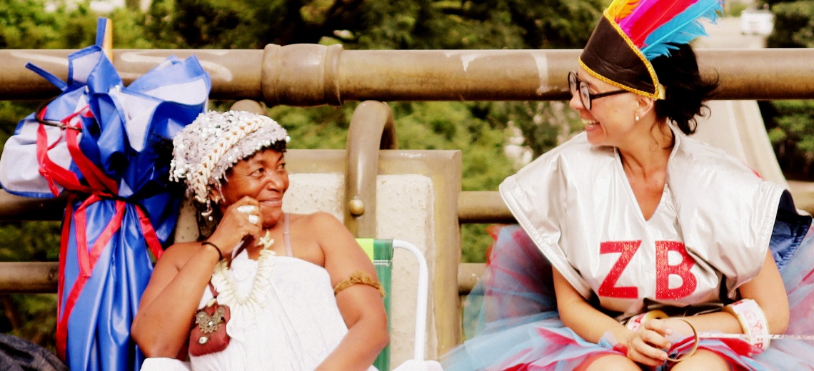 Two women smiling at each other.