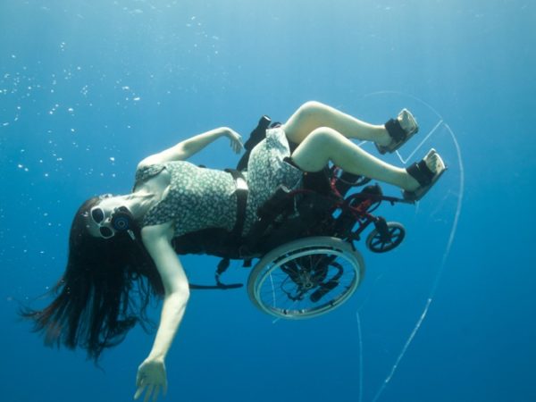 Sue Austin in an underwater wheelchair turned on her side