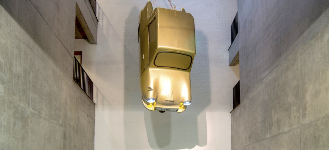 Invacar painted gold suspended from the ceiling