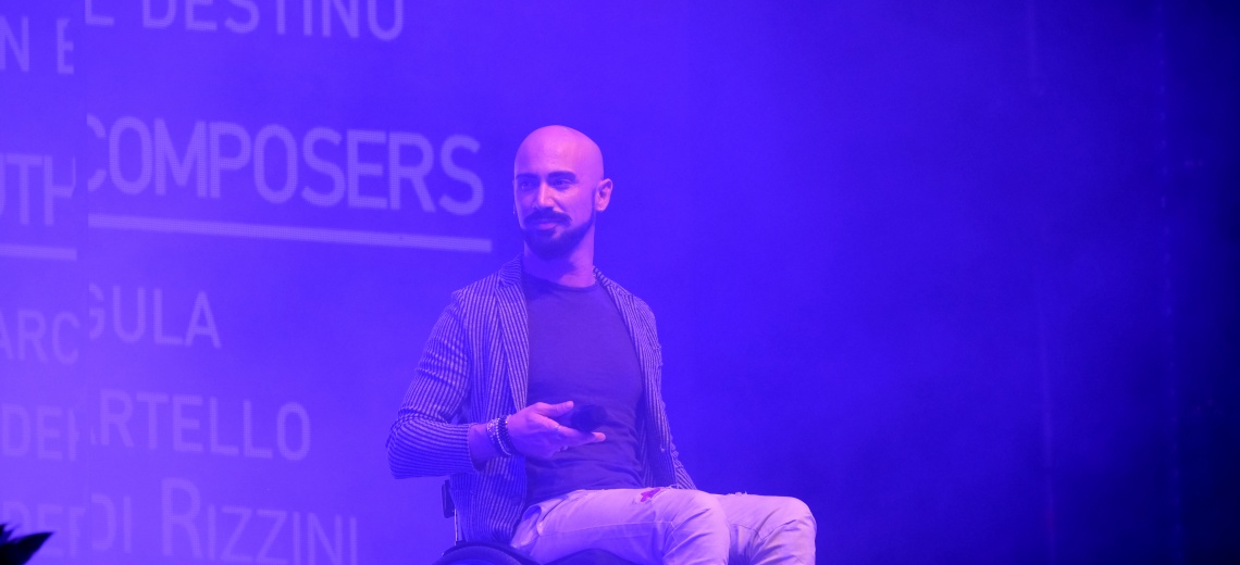 A man sitting in a wheelchair on a stage