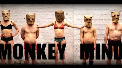 Three men and two women in a row wearing only underwear and a paper bag on their heads.