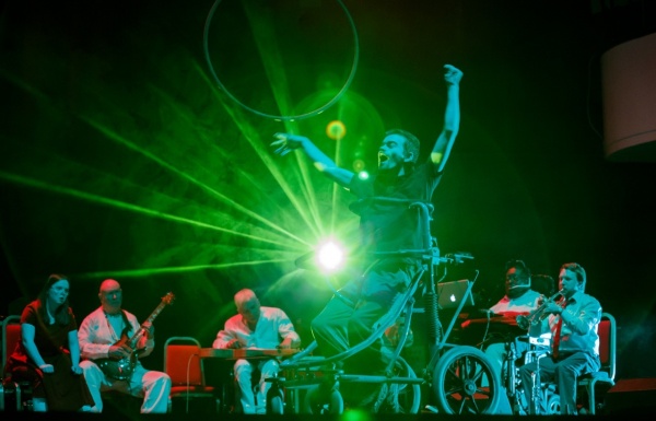 Photograph of a performance with green lighting