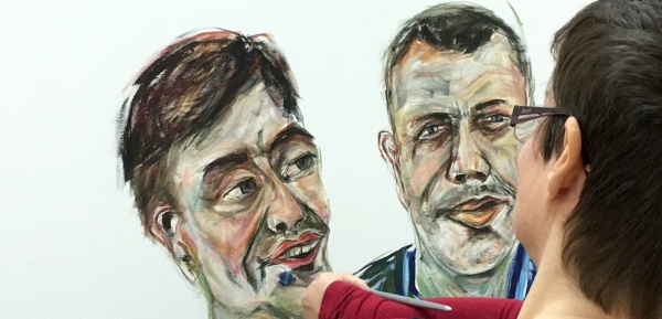 A photograph of Tanya Raabe-Webber doing a portrait of two men