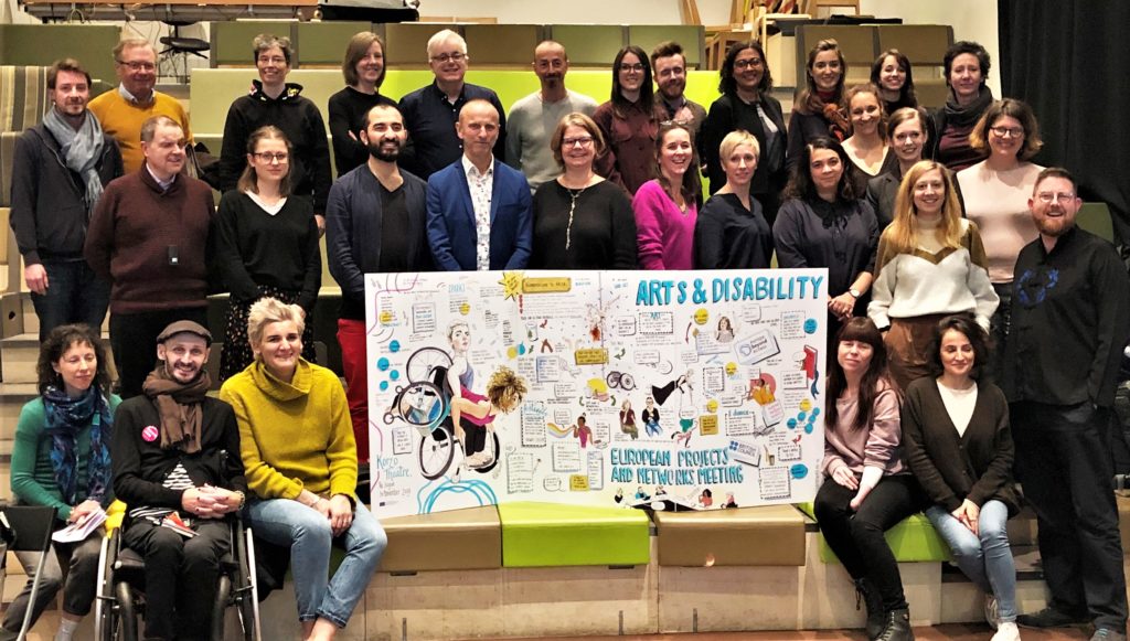 The group of 30 gather around the illustrated meeting notes with 'Arts & Disability' at the centre.