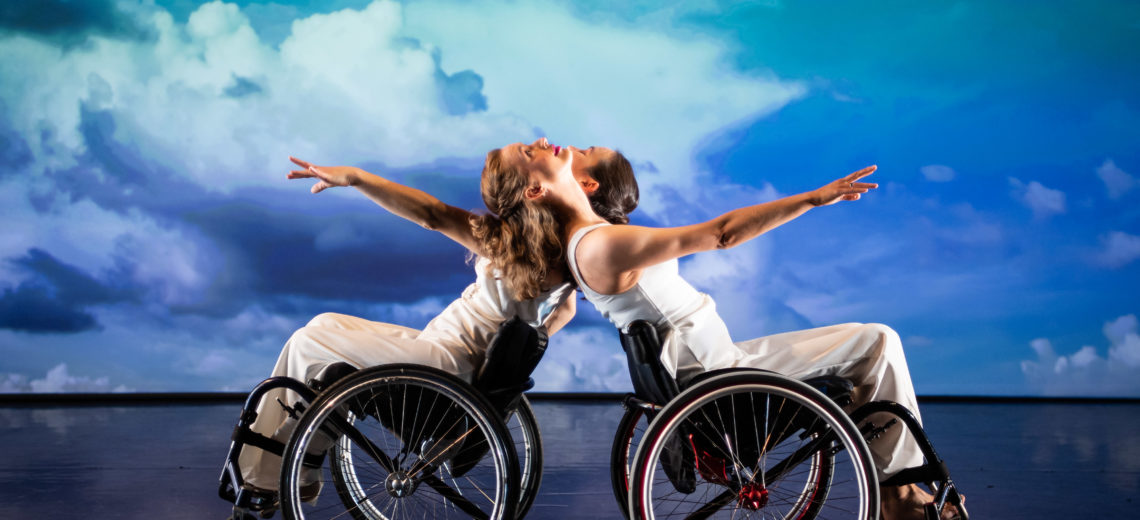 Two female wheelchair dancers on stage