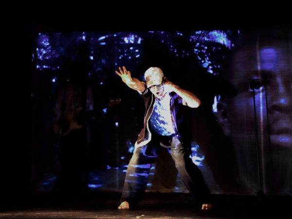 David Bower dancing in In Between Spaces with Lionel Macauley on film Blue lighting icy feel 