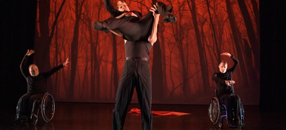 Two male wheelchair dancers and two standing dancers on stage