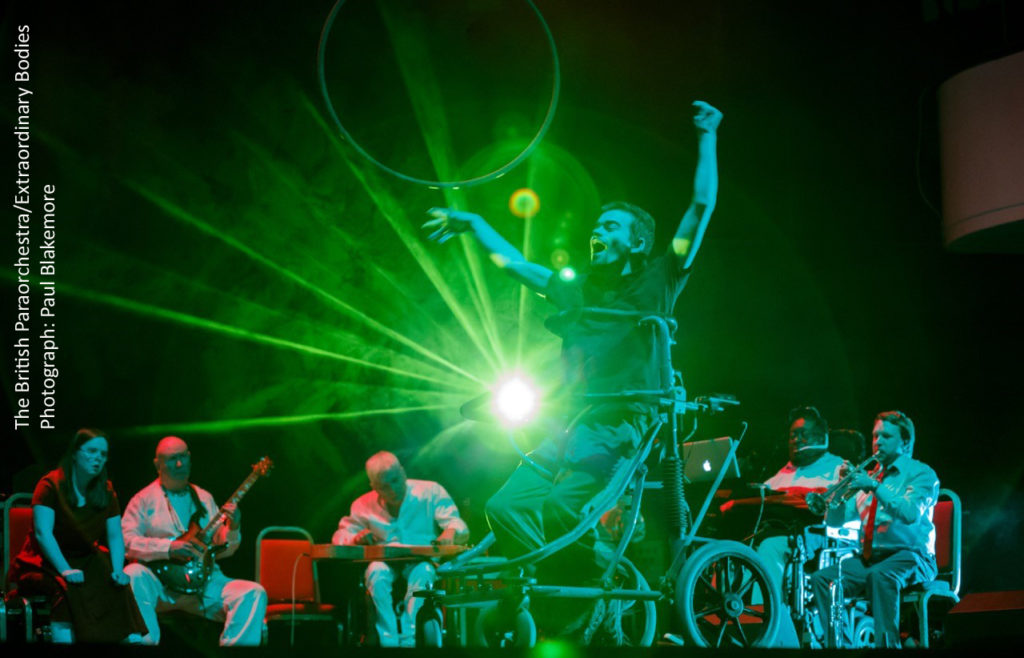Photograph of a performance with green lighting