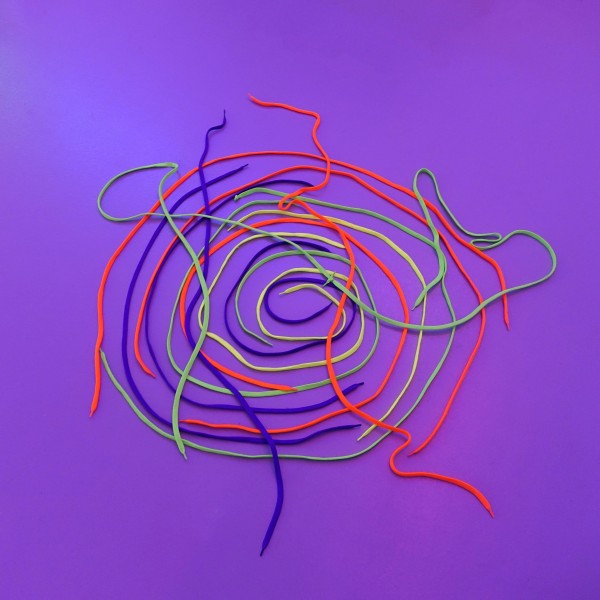 A bright purple graphic with swiggly lines in red, blue, yellow and green. These lines appear to be made with shoelaces.