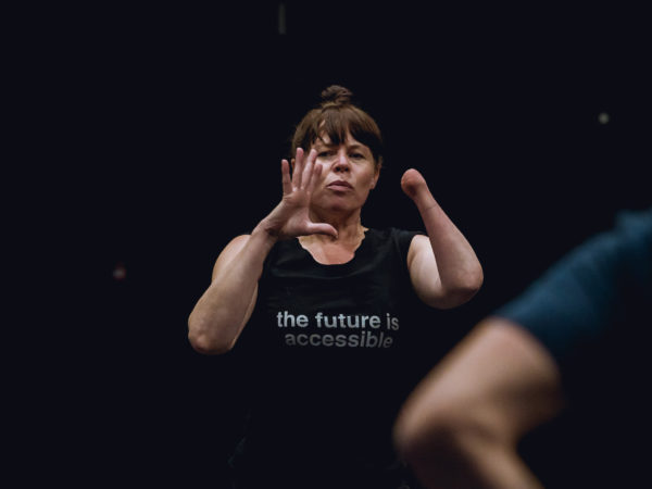 A female dancer with an amputated hand runs a dance workshop