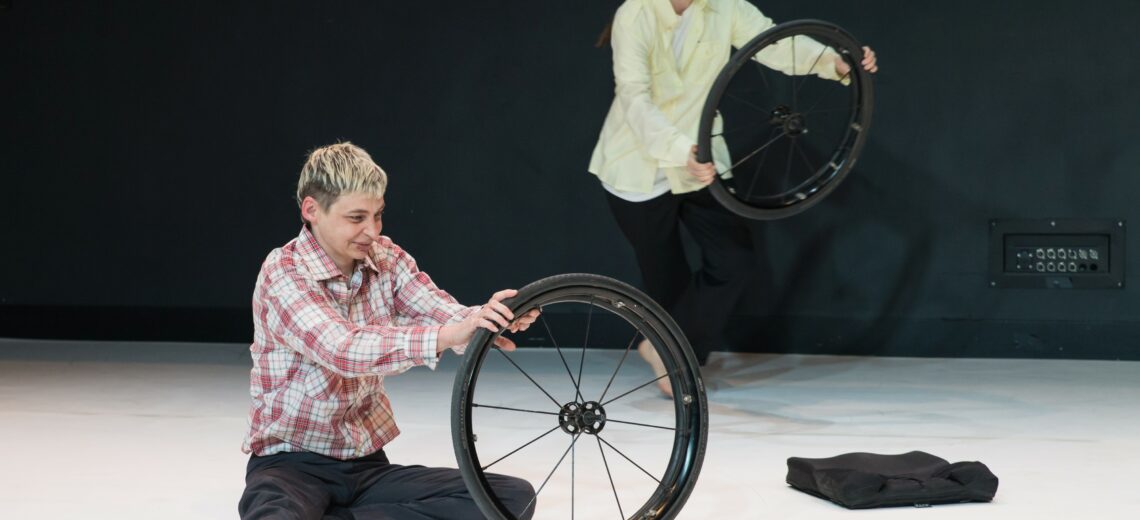 A performer deconstructs her wheelchair