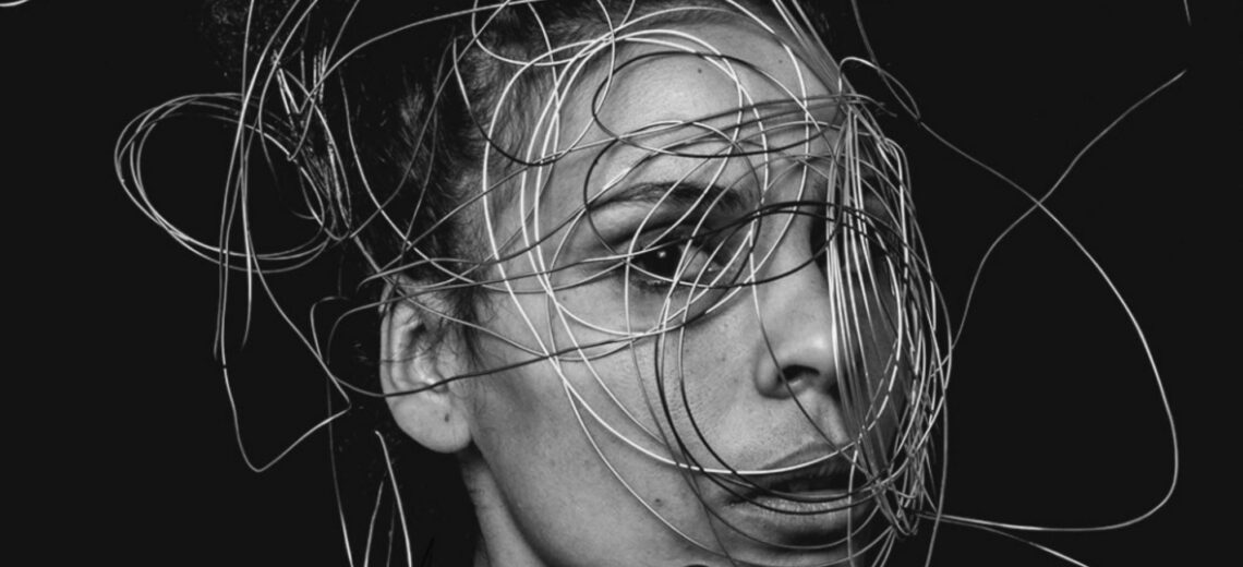 A woman with harsh wire pressed across her face