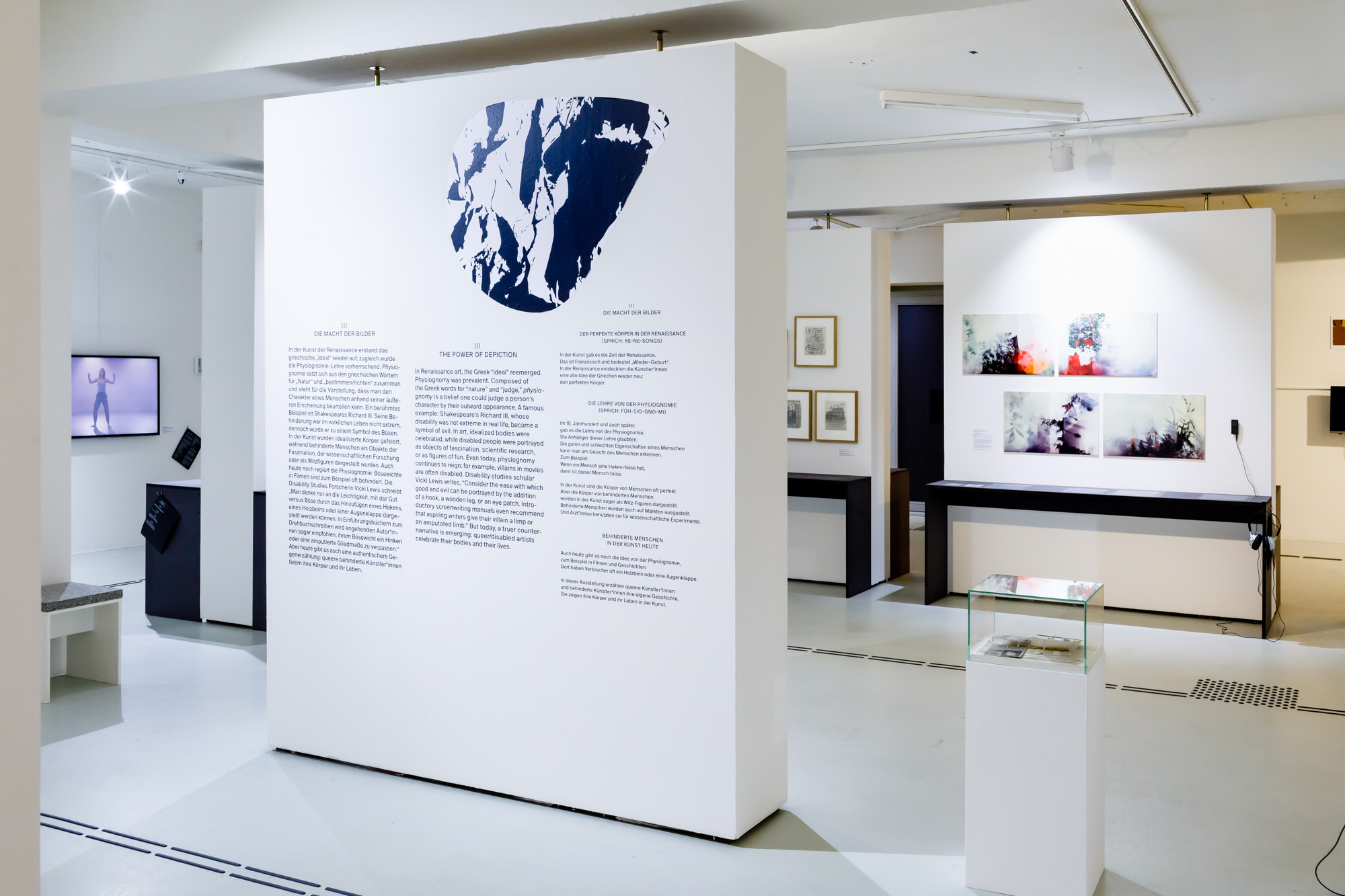 Photograph of an art exhibition with an information stand prominently featured